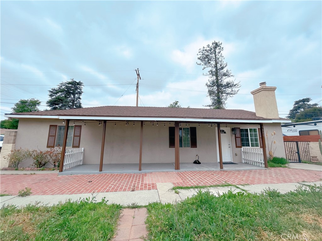 1807 Berkeley Avenue Pomona, CA 91768 - Photo 1 of 8 a front view of a house with garden