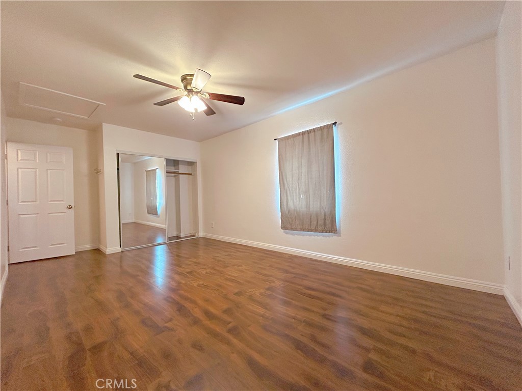 1807 Berkeley Avenue Pomona, CA 91768 - Photo 5 of 8 a view of empty room with wooden floor and fan