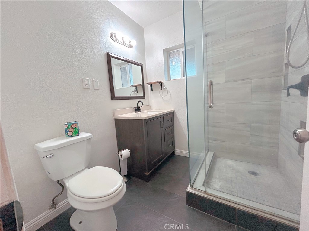 1807 Berkeley Avenue Pomona, CA 91768 - Photo 7 of 8 a bathroom with a sink toilet and shower