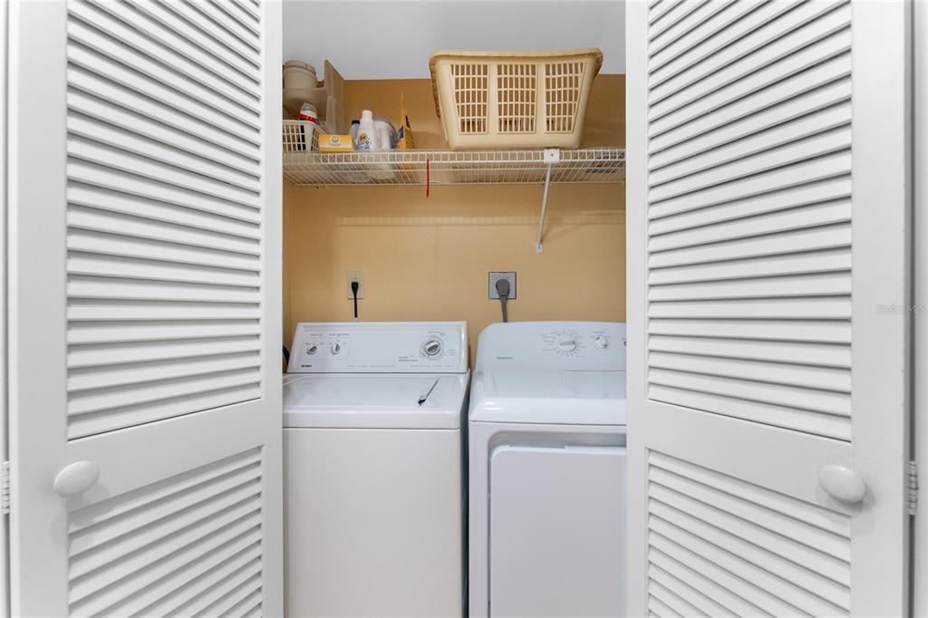 2700 North Beach Road, Unit E107 Englewood, FL 34223 - Photo 15 of 62 a utility room with dryer and washer