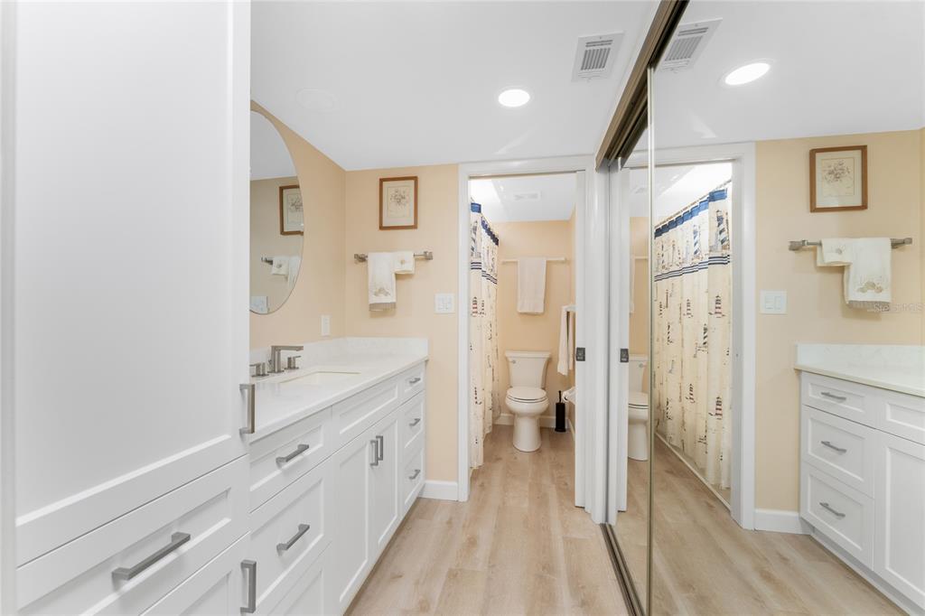 2700 North Beach Road, Unit E107 Englewood, FL 34223 - Photo 23 of 62 a spacious bathroom with a double vanity sink a toilet and a shower