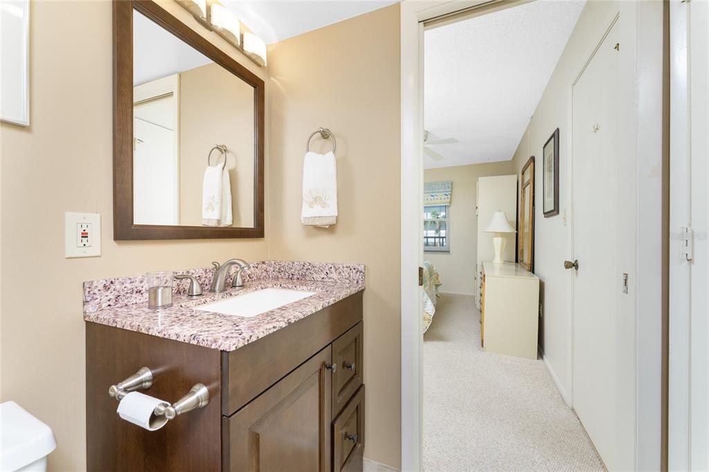 2700 North Beach Road, Unit E107 Englewood, FL 34223 - Photo 29 of 62 a bathroom with a sink and a mirror