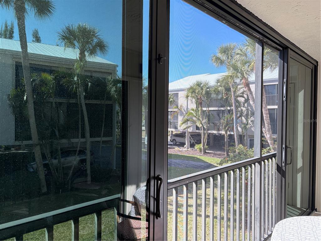 2700 North Beach Road, Unit E107 Englewood, FL 34223 - Photo 33 of 62 a view of a glass door with a balcony from a window