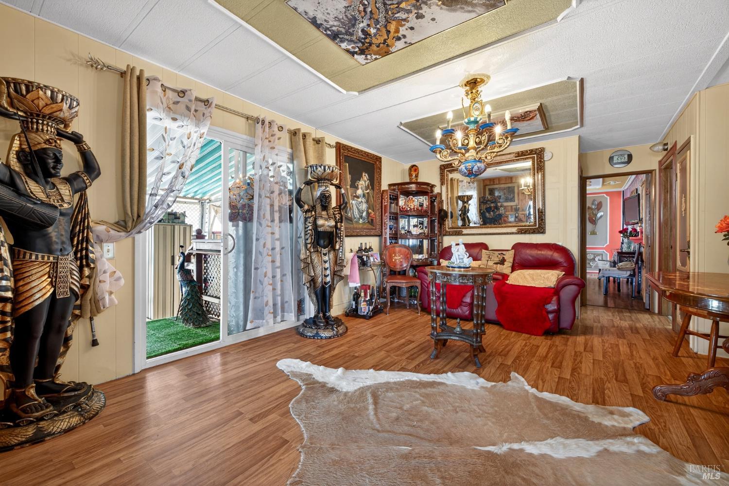 145 Círculo Todos Rohnert Park, CA 94928 - Photo 12 of 39 a living room filled with furniture a chandelier and a large window