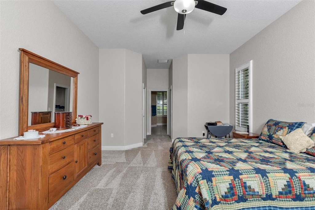 1989 Northwest 111th Loop Ocala, FL 34475 - Photo 20 of 55 a bedroom with a bed and a chandelier