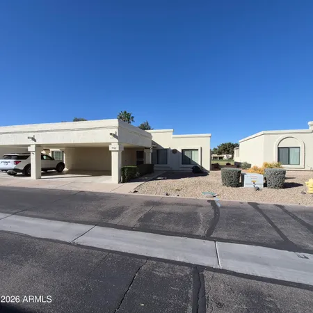 a front view of a house with a road