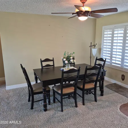 a view of a dining room with furniture and window