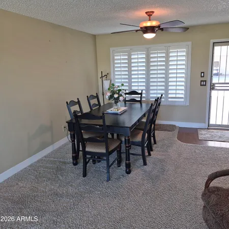 a view of a dining room with furniture and window