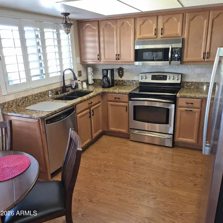 a kitchen with a stove a sink and a microwave