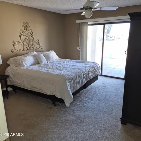 a spacious bedroom with a bed and a window