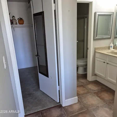 a large bed sitting in a bedroom next to a window
