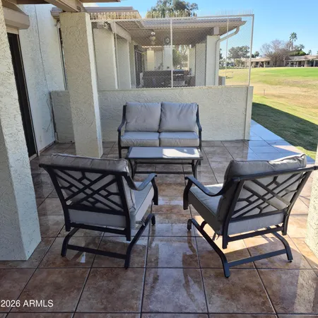 a view of a swimming pool with outdoor seating