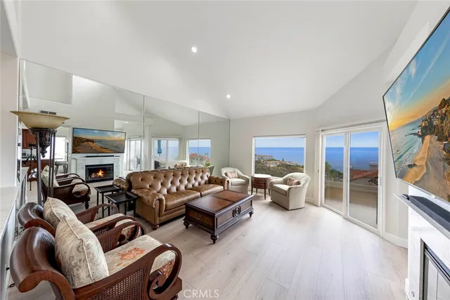 a living room with furniture flat screen tv and a fireplace