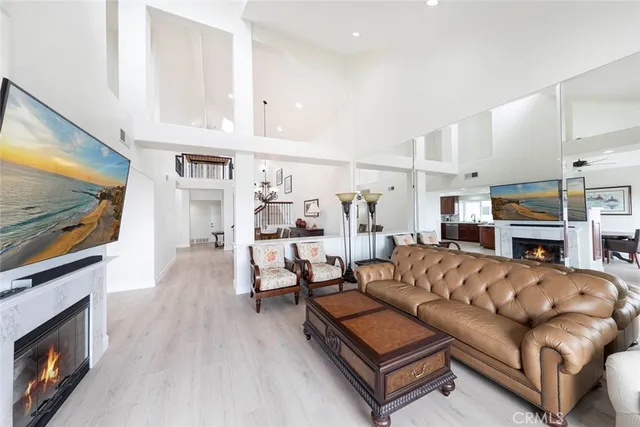 a living room with stainless steel appliances kitchen island furniture and a view of kitchen