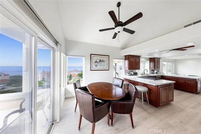 a view of a dining room with furniture and a potted plant