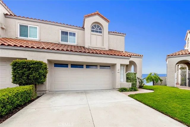 a view of a house with a garden and plants