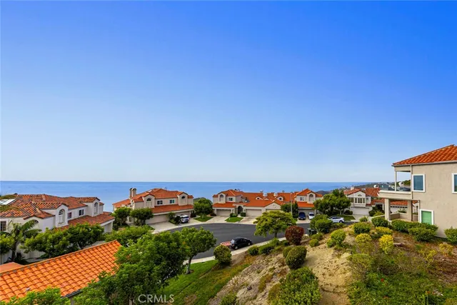 a view of a hallway with wooden floor and a chandelier