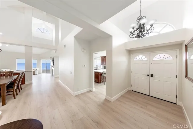 a view of a dining room with furniture wooden floor and chandelier