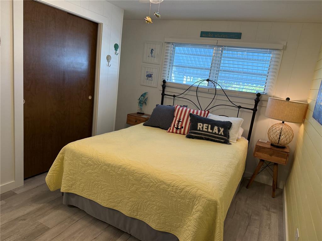 5691 Teahouse Road Venice, FL 34293 - Photo 12 of 31 a bedroom with a bed and wooden floor