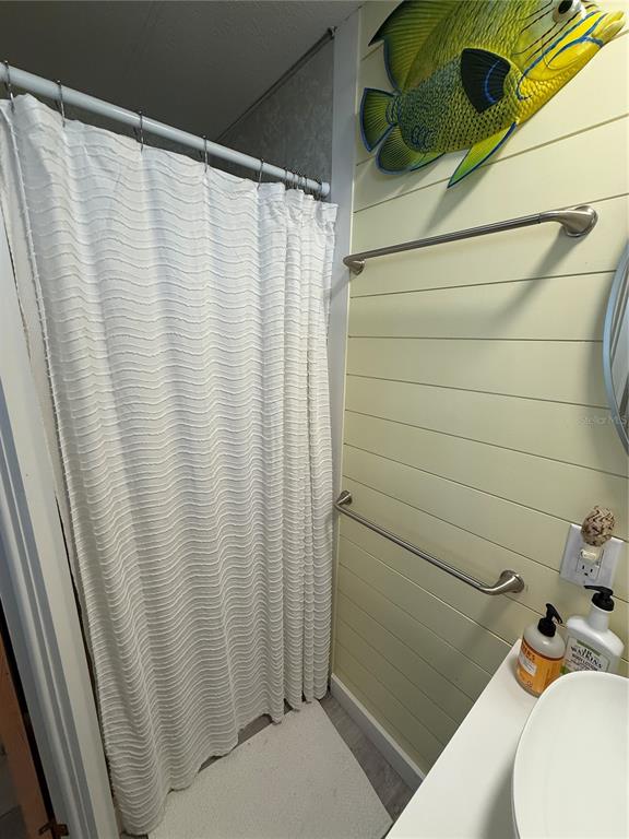 5691 Teahouse Road Venice, FL 34293 - Photo 15 of 31 a bathroom with a shower curtain and sink