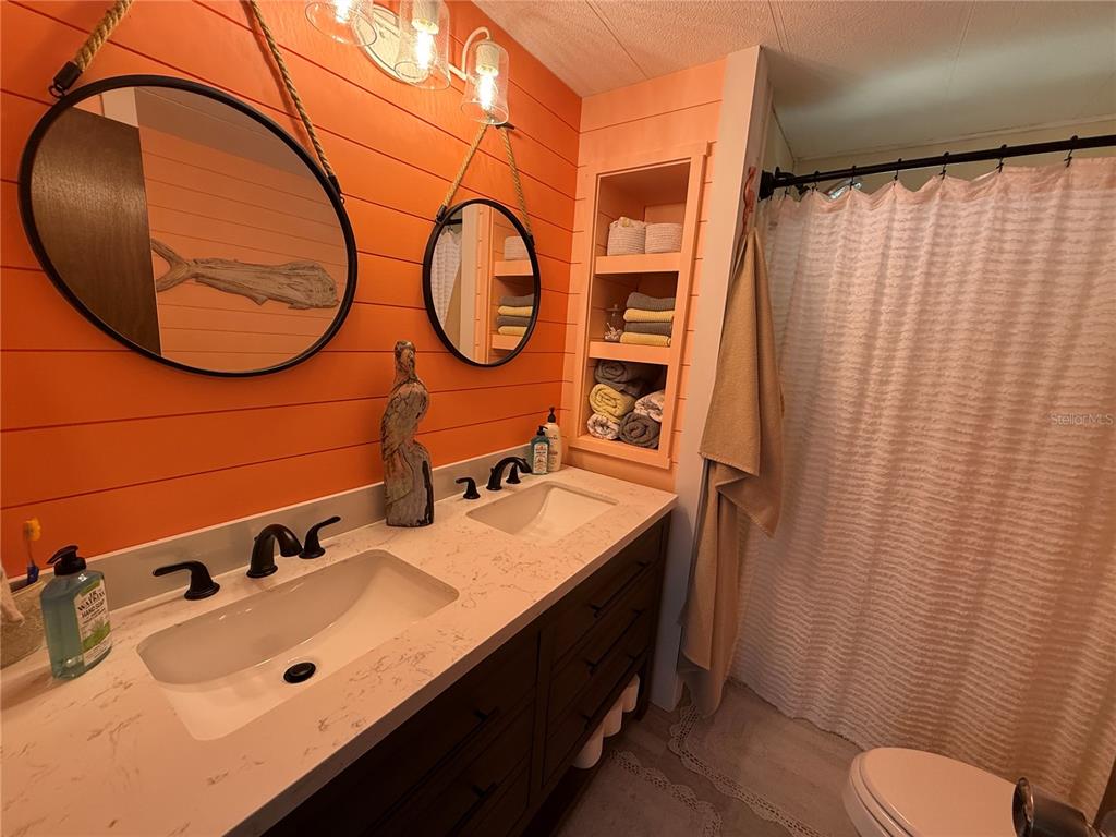 5691 Teahouse Road Venice, FL 34293 - Photo 18 of 31 a bathroom with a sink and a mirror