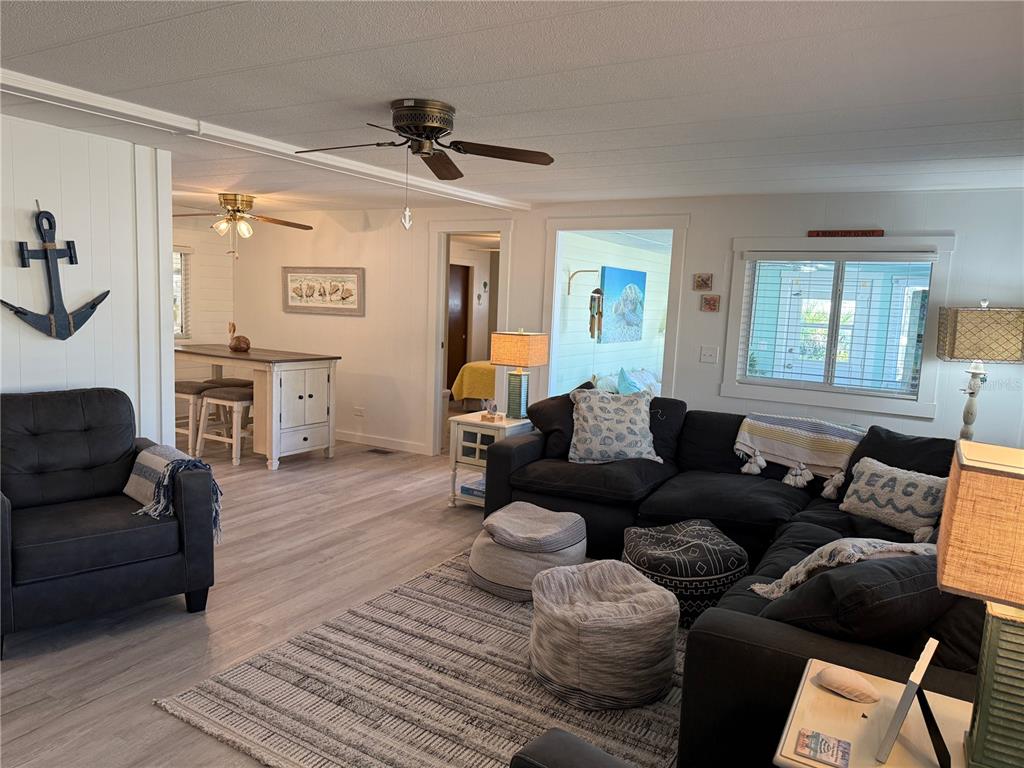 5691 Teahouse Road Venice, FL 34293 - Photo 5 of 31 a living room with furniture and a wooden floor