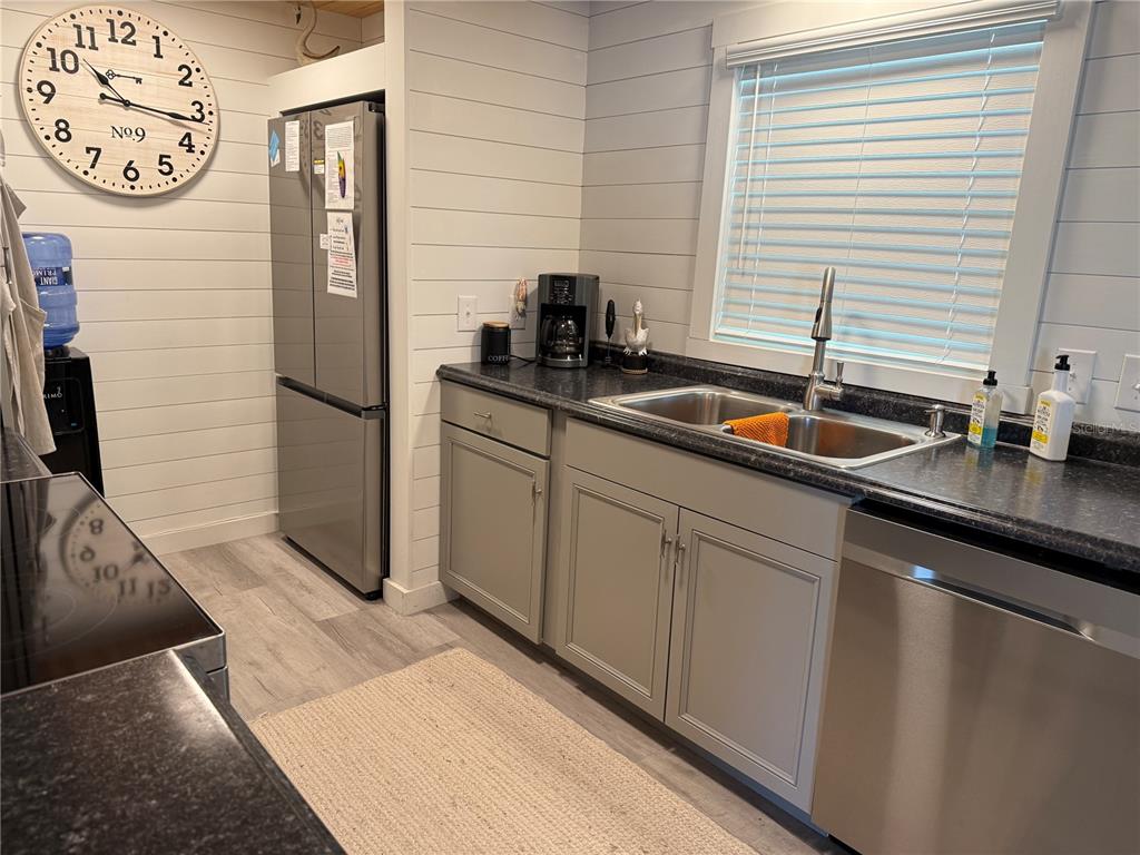 5691 Teahouse Road Venice, FL 34293 - Photo 8 of 31 a kitchen with stainless steel appliances granite countertop a sink and a refrigerator