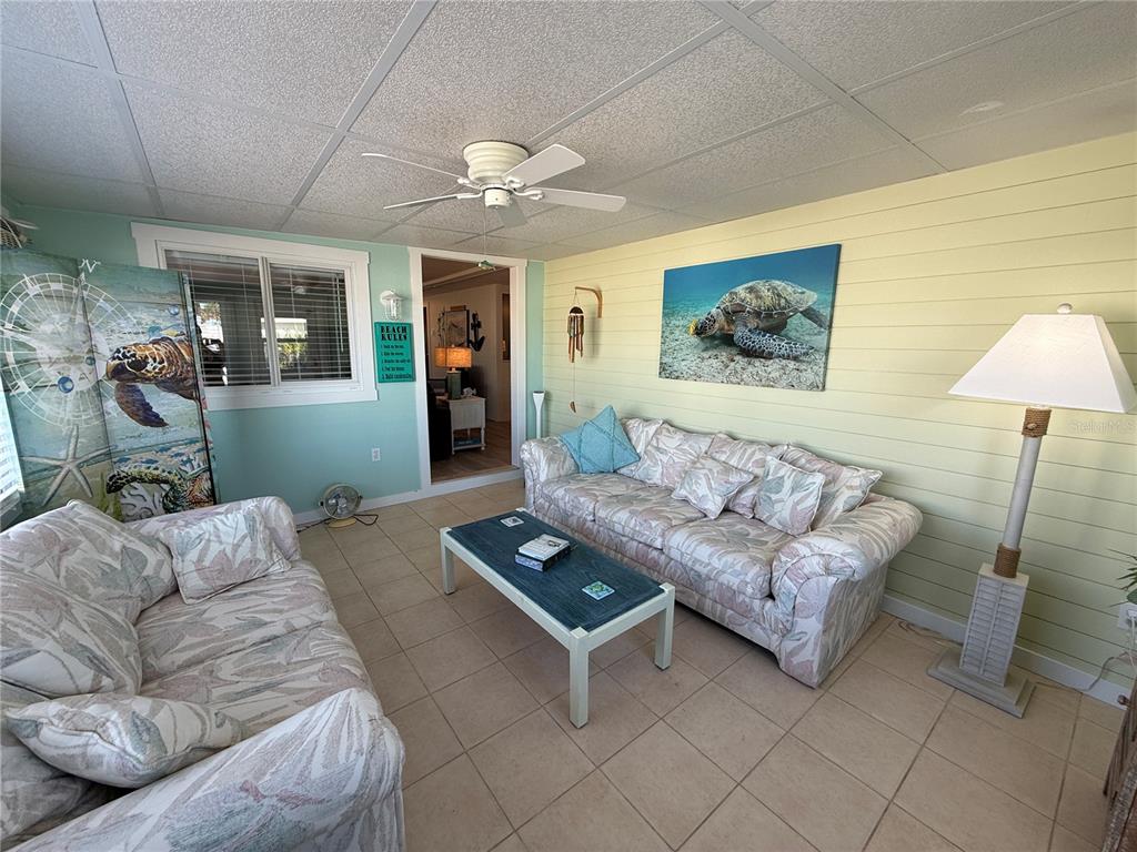 5691 Teahouse Road Venice, FL 34293 - Photo 10 of 31 a living room with furniture and a table