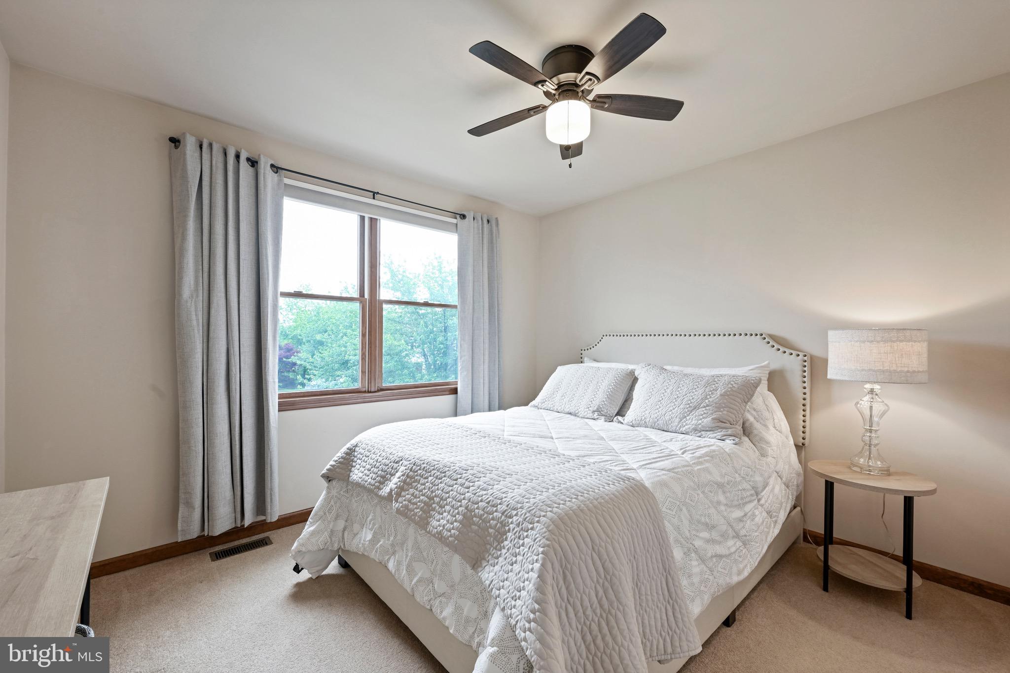 329 Hunter Path Road Hummelstown, PA 17036 - Photo 19 of 37 a bedroom with a large bed and a chandelier