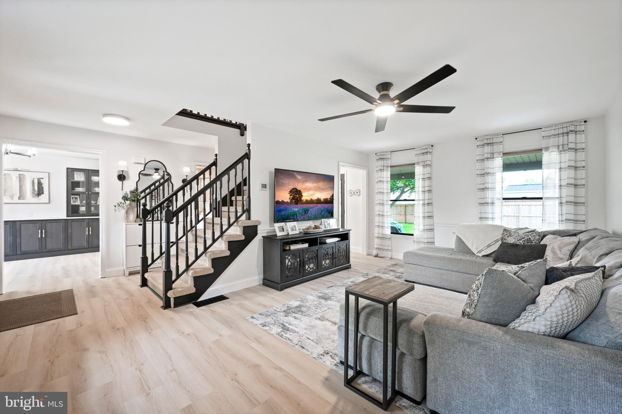 329 Hunter Path Road Hummelstown, PA 17036 - Photo 6 of 37 a living room with furniture ceiling fan and a wooden floor
