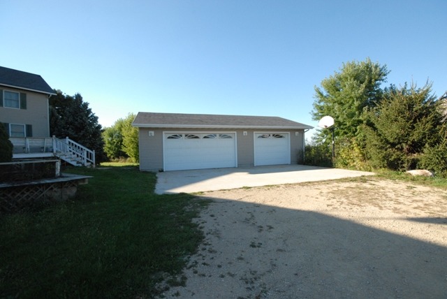 16129 Kelley Road Pecatonica, IL 61063 - Photo 2 of 22 a view of a house with a yard and garage