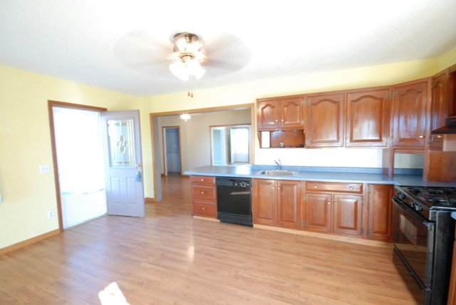 16129 Kelley Road Pecatonica, IL 61063 - Photo 3 of 22 a large kitchen with stainless steel appliances granite countertop a stove and cabinets