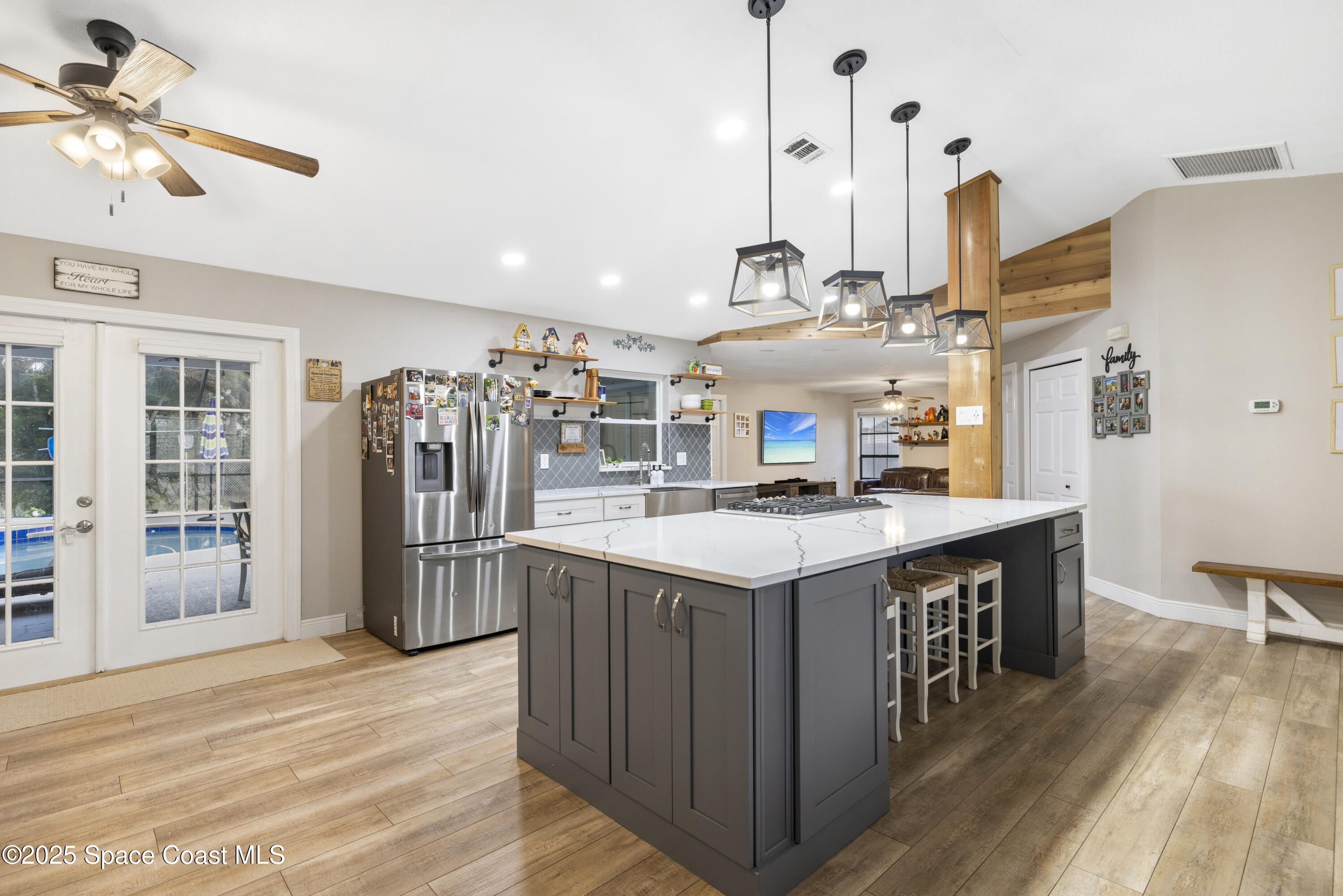 456 Narragansett Street Northeast Palm Bay, FL 32907 - Photo 11 of 43 a kitchen with stainless steel appliances granite countertop a sink a stove and a wooden floor