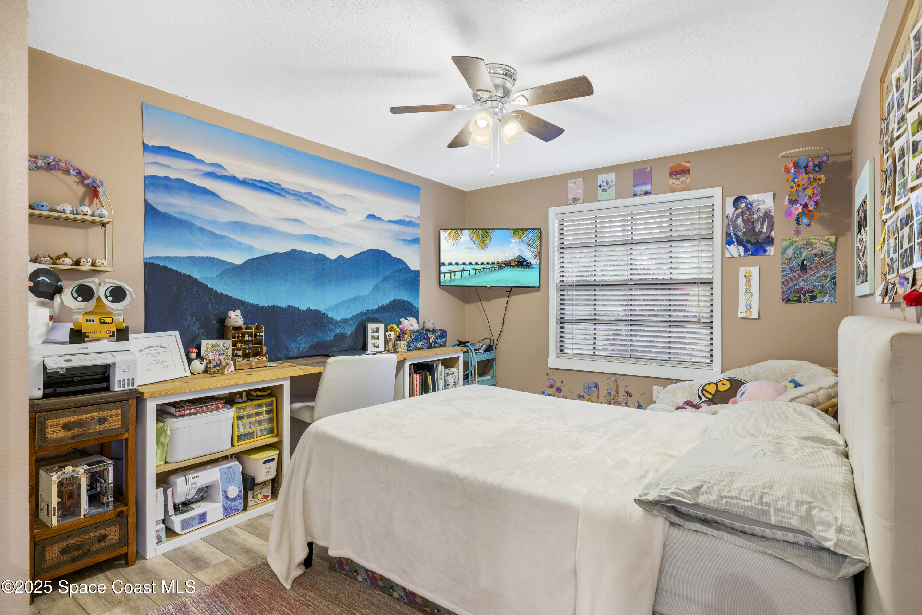 456 Narragansett Street Northeast Palm Bay, FL 32907 - Photo 27 of 43 a bed room with a bed and a book shelf