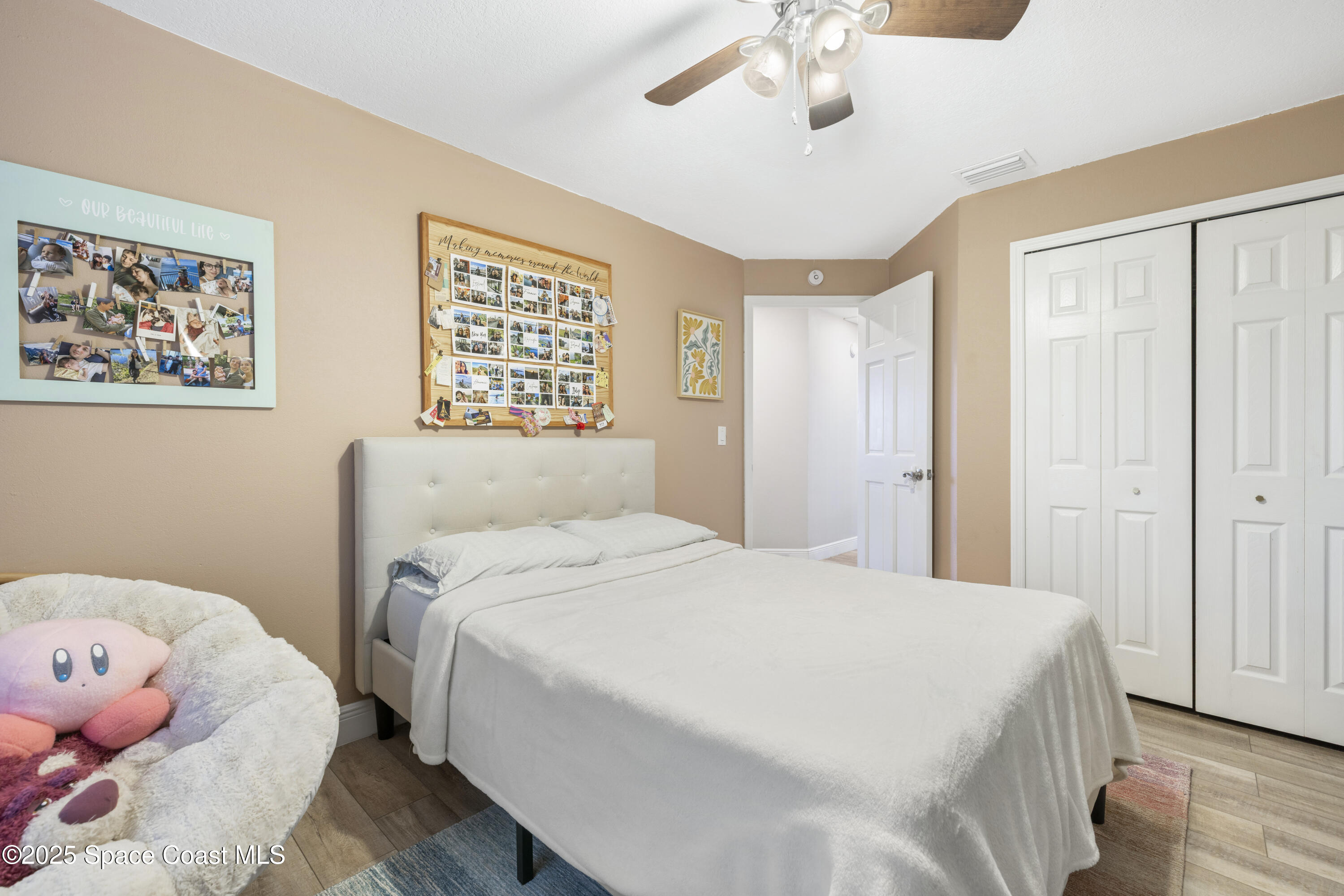 456 Narragansett Street Northeast Palm Bay, FL 32907 - Photo 28 of 43 a bedroom with a bed and chandelier