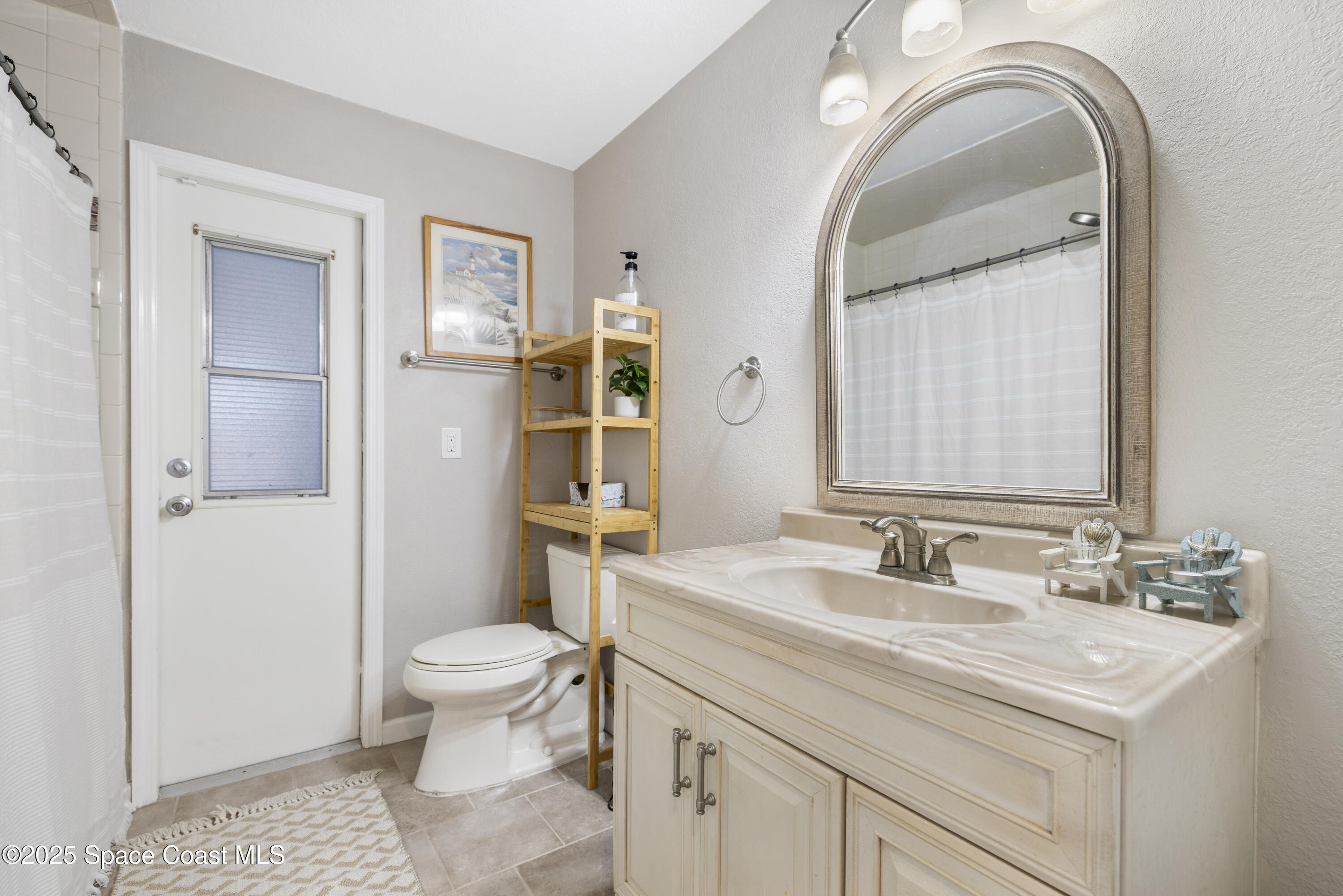 456 Narragansett Street Northeast Palm Bay, FL 32907 - Photo 29 of 43 a bathroom with a sink a toilet and a mirror