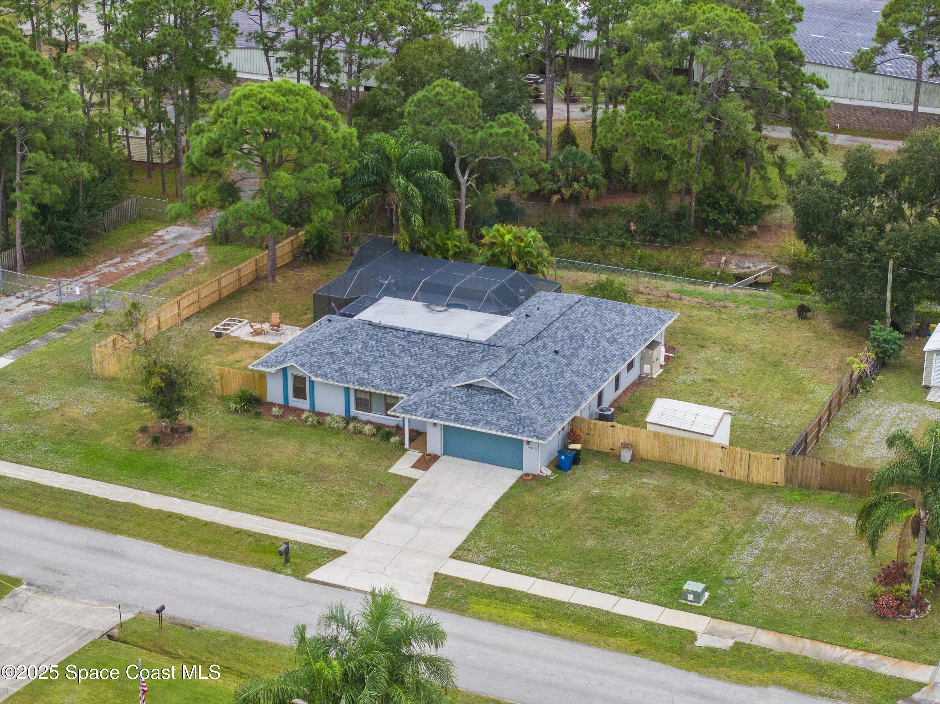 456 Narragansett Street Northeast Palm Bay, FL 32907 - Photo 3 of 43 an aerial view of a house with swimming pool and green space