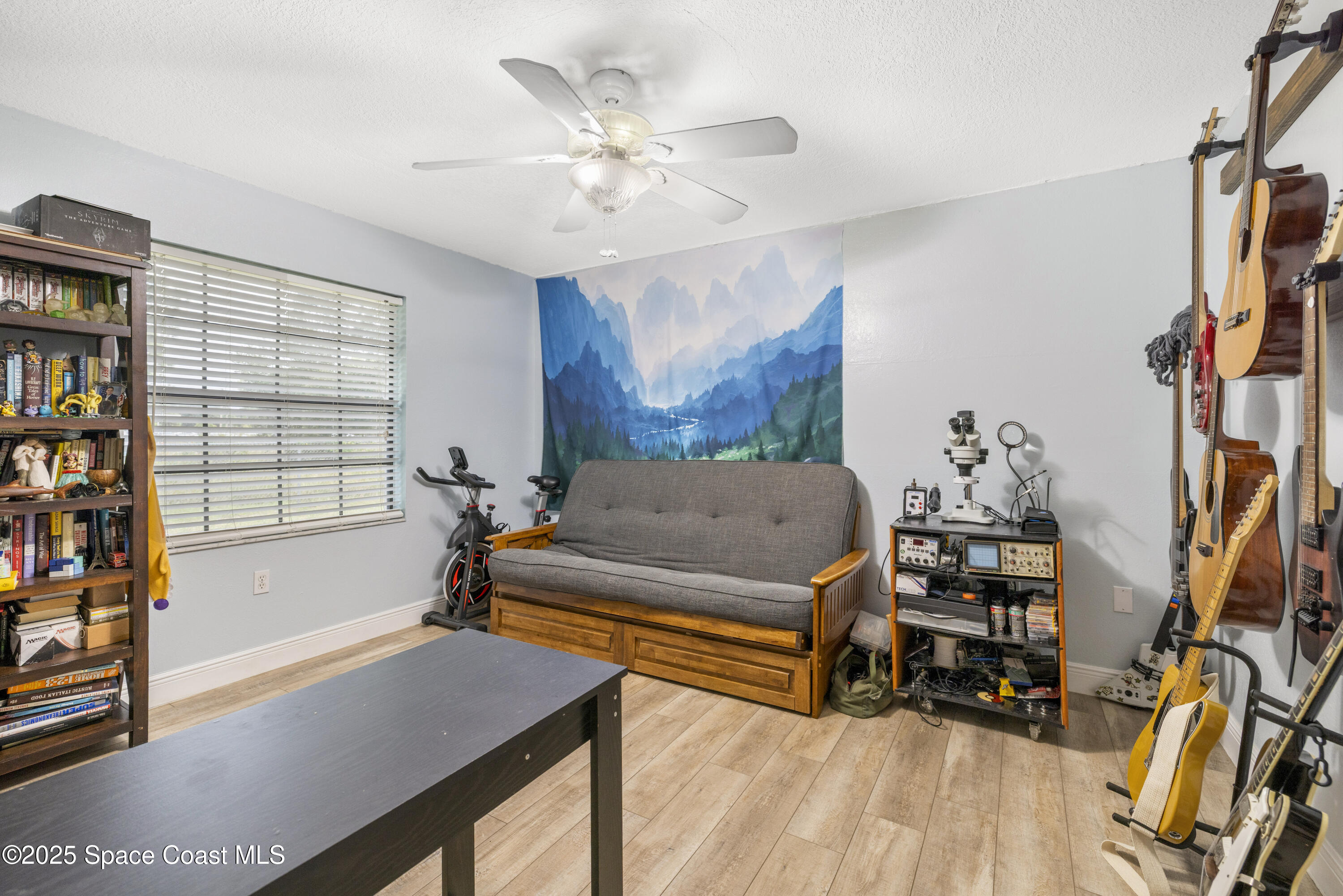 456 Narragansett Street Northeast Palm Bay, FL 32907 - Photo 31 of 43 a bedroom with furniture and a book shelf