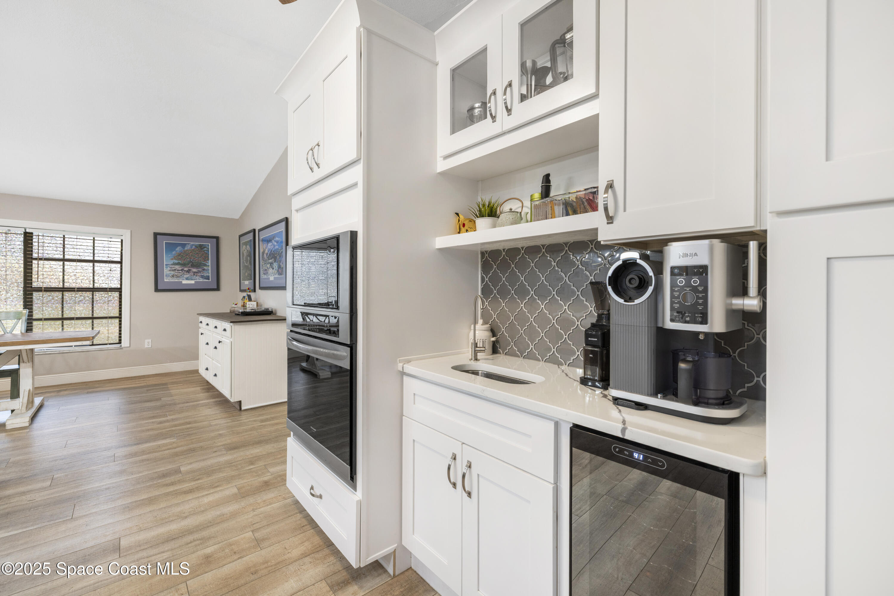 456 Narragansett Street Northeast Palm Bay, FL 32907 - Photo 8 of 43 a kitchen with stainless steel appliances granite countertop a refrigerator a stove and a wooden floors