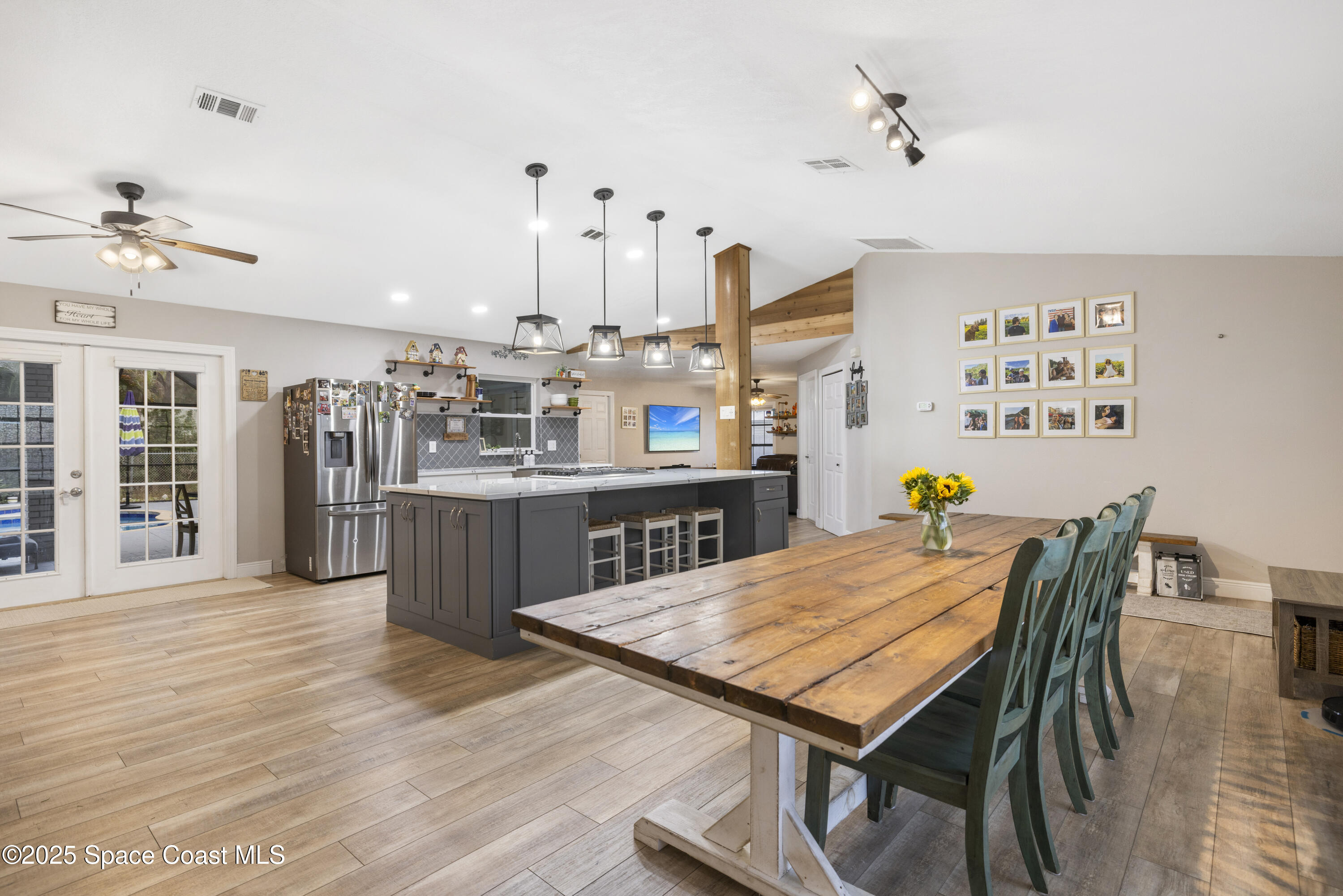 456 Narragansett Street Northeast Palm Bay, FL 32907 - Photo 10 of 43 a view of a dining room with furniture and wooden floor