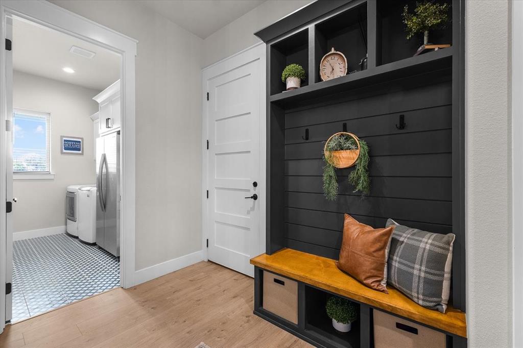 1059 Sweeney Way Weatherford, TX 76087 - Photo 26 of 37 Mudroom just outside garage door with dark shiplap backing, wooden bench seating, and integrated storage cubbies