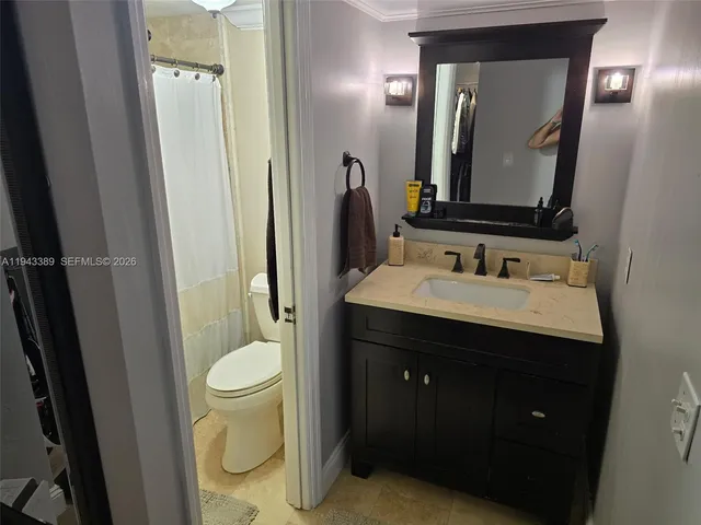 a bathroom with a sink vanity and a mirror