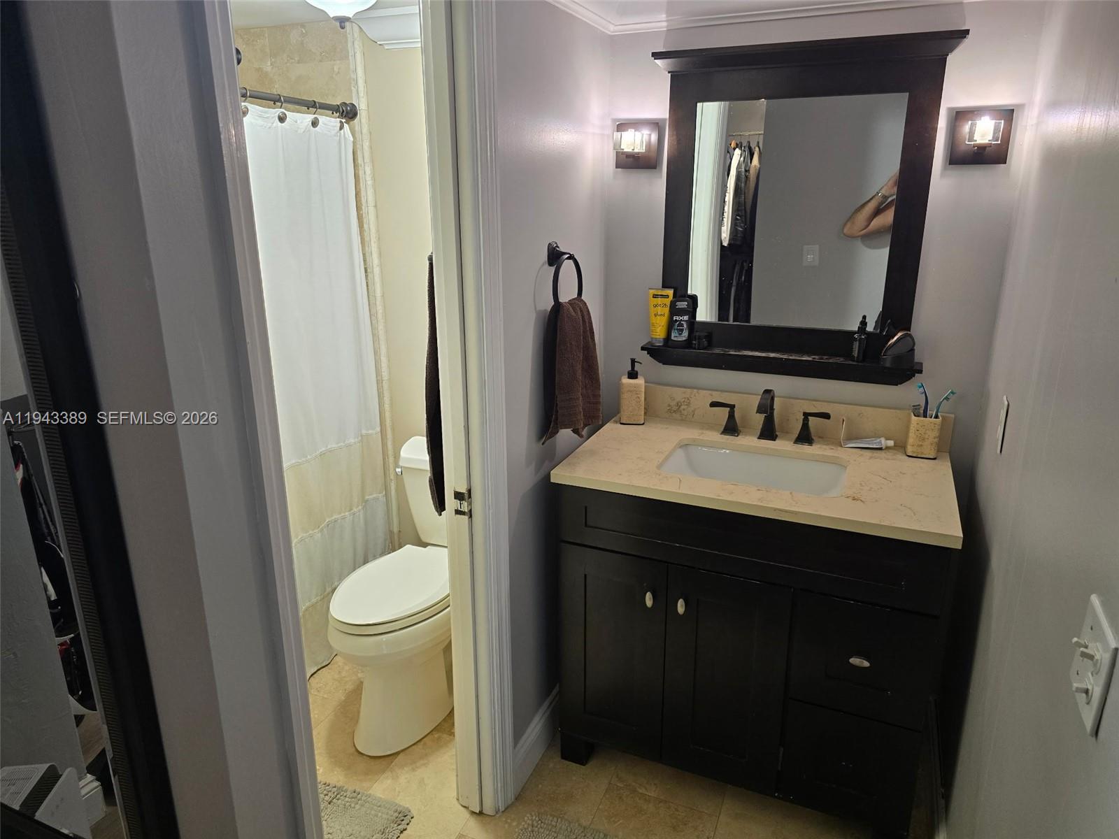 7753 Southwest 102nd Place Miami, FL 33173 - Photo 8 of 18 a bathroom with a sink vanity and a mirror