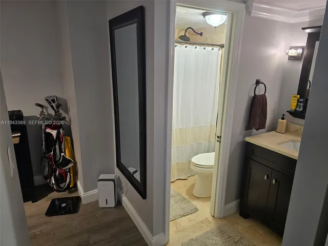 a bathroom with a toilet a sink and shower