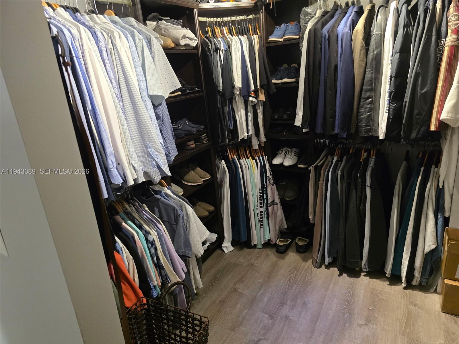 7753 Southwest 102nd Place Miami, FL 33173 - Photo 10 of 18 a view of walk in closet with clothes and shoes