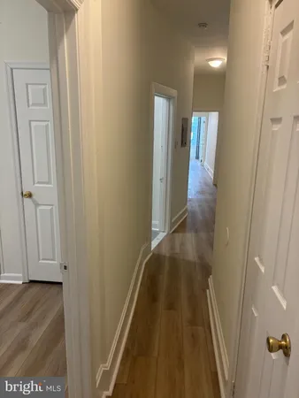 a view of hallway with wooden floor