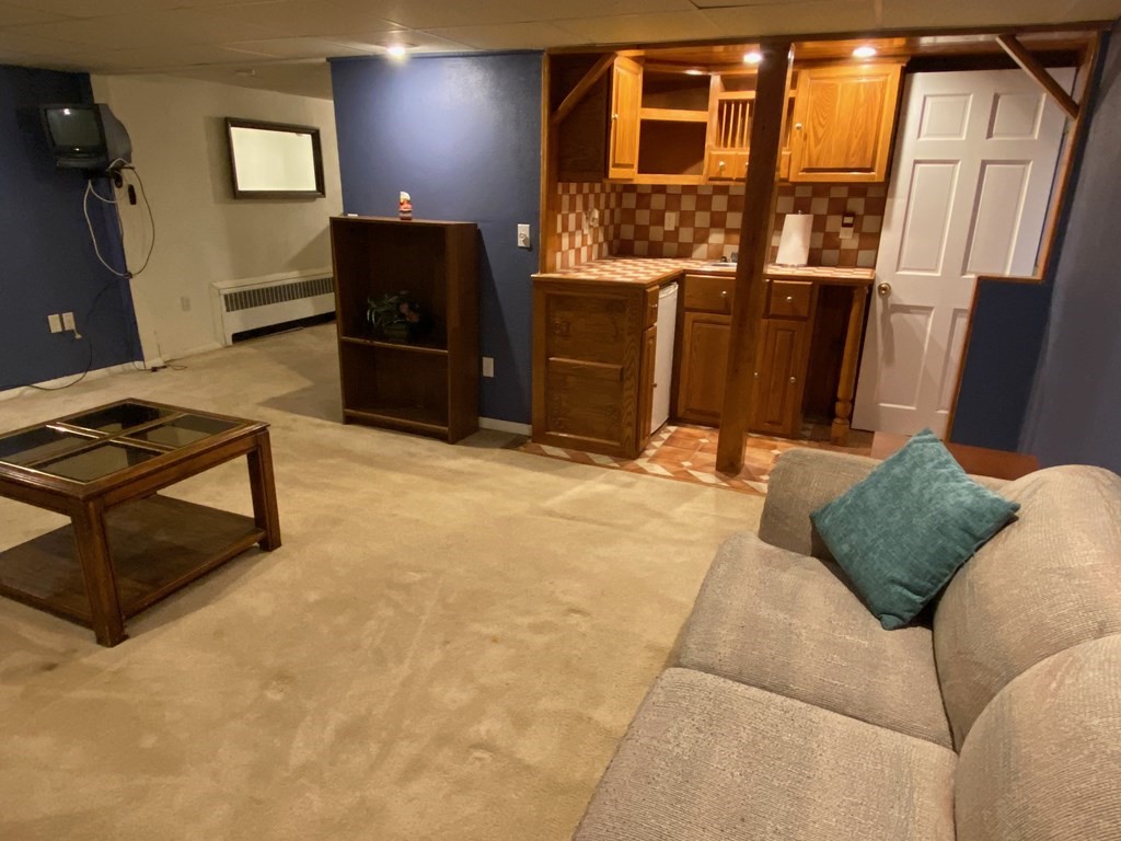16 Worcester Road Townsend, MA 01469 - Photo 23 of 31 a living room with furniture and a flat screen tv
