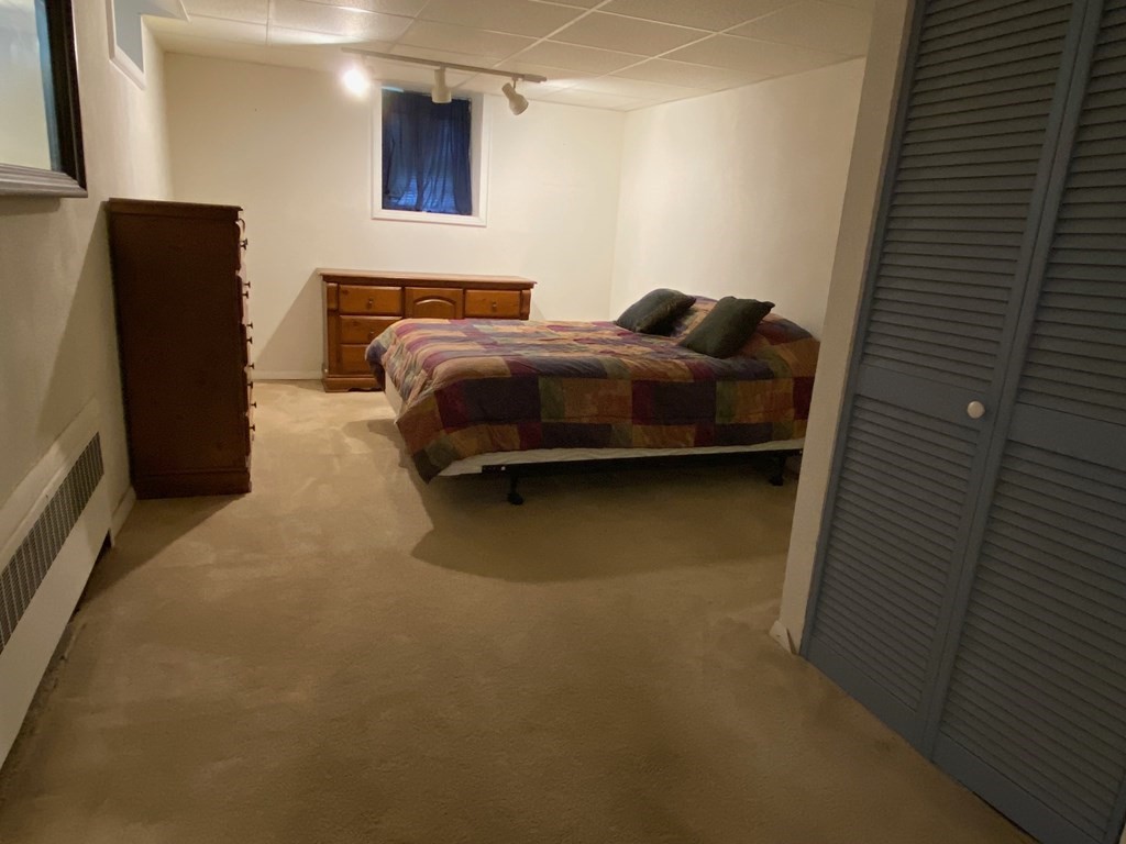 16 Worcester Road Townsend, MA 01469 - Photo 25 of 31 a bedroom with a bed and a black wall painting