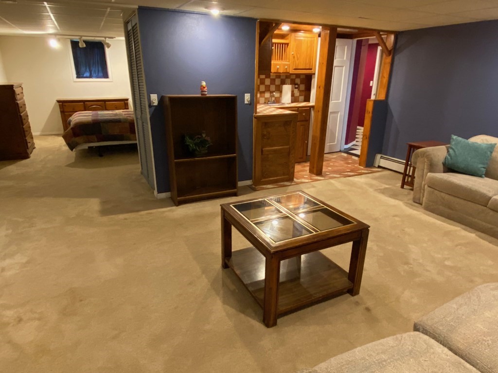 16 Worcester Road Townsend, MA 01469 - Photo 28 of 31 a living room with furniture a flat screen tv and a refrigerator