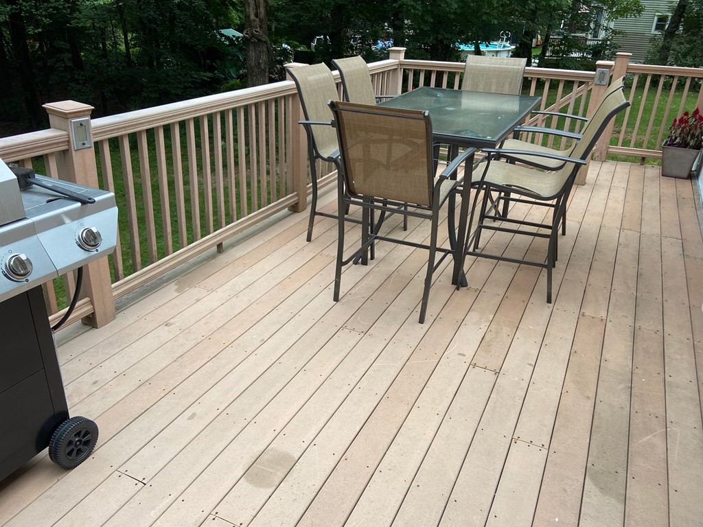16 Worcester Road Townsend, MA 01469 - Photo 30 of 31 a view of a roof deck with table and chairs wooden floor and fence